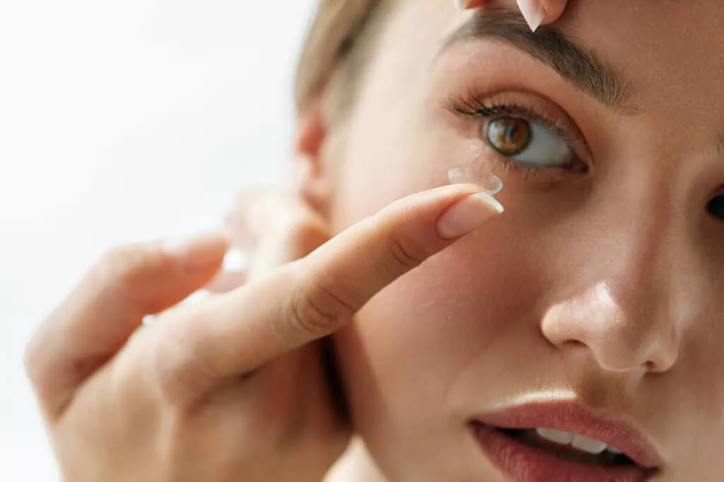 A Woman Inserting A Contact Lens In Eye | Rosley Eyecare & Associates in Glenview, IL