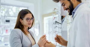 Woman receiving expert guidance during a Frame Style Consultation in Glenview, IL, selecting eyeglass frames that suit her face shape